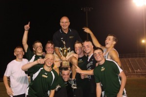 Varsity coach Earl Brewer, is held over the head of his players after a 12-5 victory over Loudoun ValleyPhoto courtesy of Clark Anderson