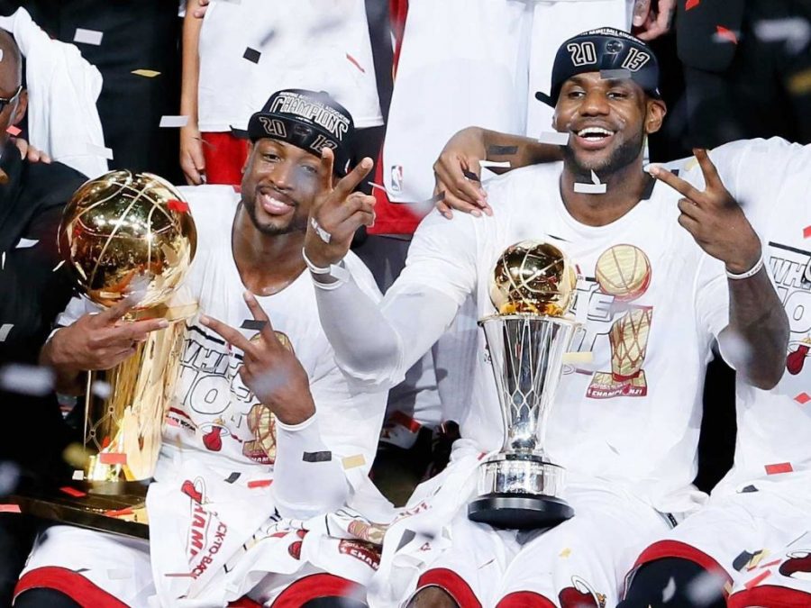 Miami Heat superstars LeBron James and Dwyane Wade celebrate after winning the NBA Championship last season (photo by Kevin C. Cox/Getty Images).