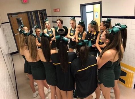 Cuinn Casey gives motivational pep talk to fellow varsity cheerleaders before a competition.