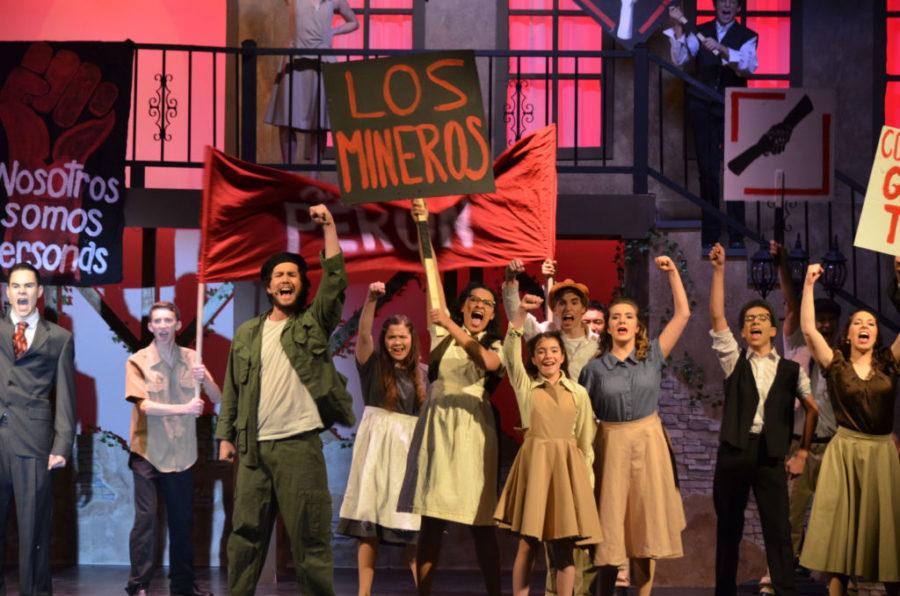 The cast of Evita lift their arms onstage during their final performing song (Photo by Mia Givens).