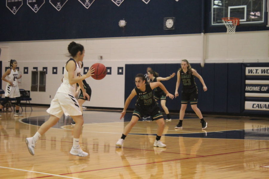 Annabeth Holsinger (9) guards Cavalier, Rachel Shurberg (12), as Kylie Allen (10) positions herself in help defense. Allen scored 11 points in the game, making her the second highest scorer of both teams. 