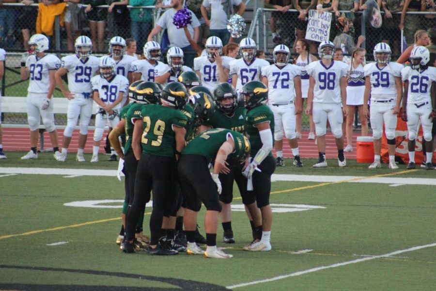 The Langley Saxons huddle on the field following a defensive play (Photo by Colleen Sherry).