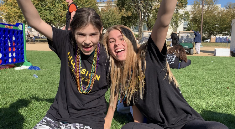 Junior Ashley Gonzalez and junior Cate Poliquin cheer after finishing the walk.  The Langley team managed to raise over $11,000 for the walk this year.