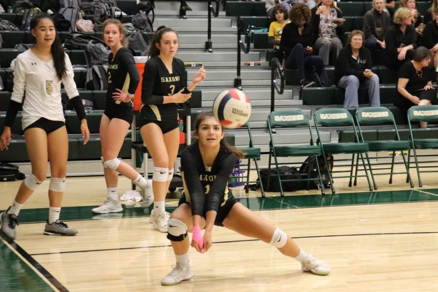 Sabrina Duque-Lewis crouches to pass the ball to her teammates during a match (Photos by Yousuf Mufti).