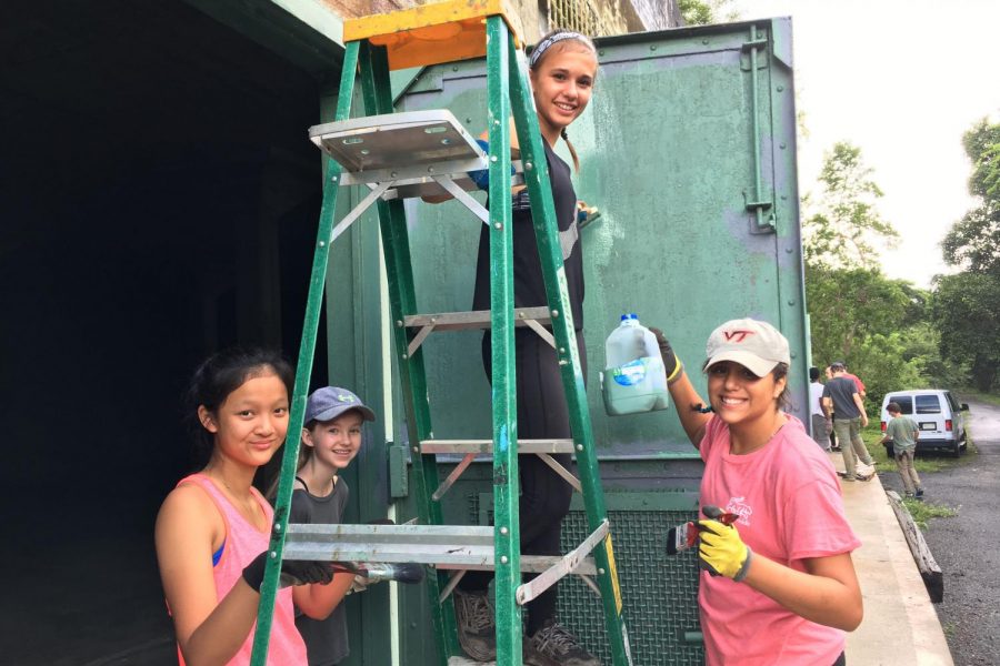 Ana El-Bogdadi stands painting a door alongside fellow volunteers in Puerto Rico. El-Bogdadi has valued community service, especially its intersections with spirituality, from a young age (Photo by El-Bogadi).
