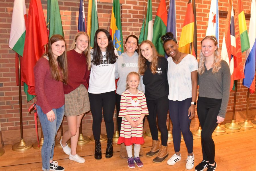 From left to right: Caroline Cassidy, Alison Buckler, Rachel Rhee-Feitel, Olivia Carnot, Katherine Moe, Laila White, and Reese Villella pose with 6-year-old Sydney Belsher, a recovered cancer patient whose story inspired the girls to take action in conjunction with the Belsher family (Photo by Belsher).