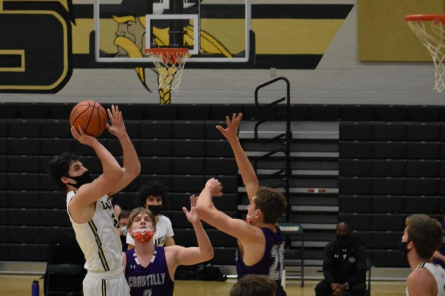 Senior Michael Hoeymans (#33) shoots and scores during the second quarter. Hoeymans finished off the game as Langleys second-highest scorer with 15 points.