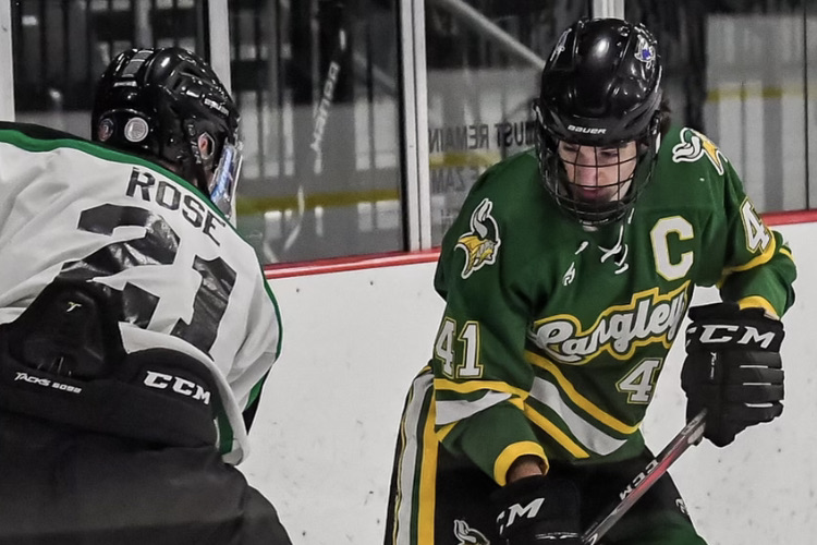 Langley hockey captain, senior Charlie Tourbaf battles for the puck in last Friday’s game against Loudoun Valley/Woodgrove. Remember to download the app, LiveBarn to watch all the action during Langley hockey games (Photo by Cahill).