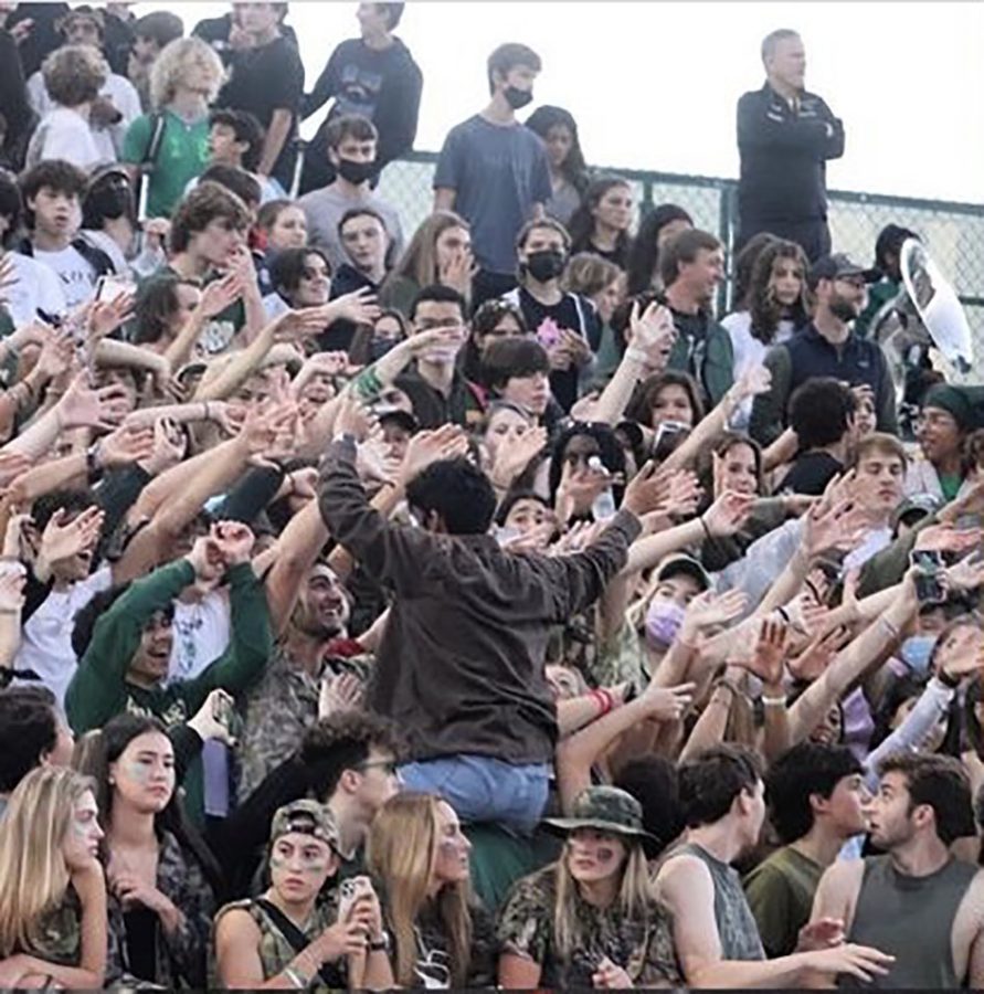 Students at Langley’s ‘Camo Out’ game, against Madison James, cheer on their team from the student section. This was Langley’s second home game of the year, and masks were not required.