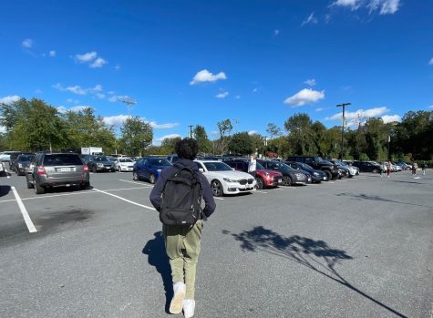 A Langley student rushes to his car to beat the traffic rush. The student ran to his nearby car in the parking lot. 

